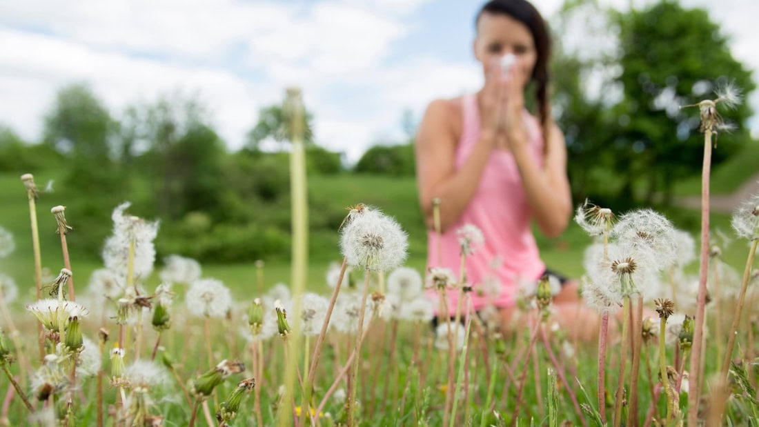Hay fever symptoms and allergy treatment in a green garden with wife.